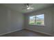 Bedroom with wood-look floors, ceiling fan and large window at 1328 Barry St, Clearwater, FL 33756