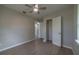 Bedroom with wood-look floors, ceiling fan, and access to bathroom at 1328 Barry St, Clearwater, FL 33756