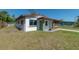 Newly renovated home with a modern exterior, featuring a green door and brown accents at 1328 Barry St, Clearwater, FL 33756