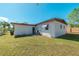 Side view of a single-story house with a grassy yard at 1328 Barry St, Clearwater, FL 33756