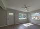 Living room featuring hardwood floors, ceiling fan, and large windows at 1328 Barry St, Clearwater, FL 33756