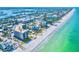 Aerial view of beachfront condos with turquoise waters, highlighting prime coastal living and neighborhood at 2618 Gulf Blvd # 407, Indian Rocks Beach, FL 33785