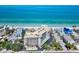 Aerial view of a beachfront condo with a pool and well maintained grounds and ocean views at 2618 Gulf Blvd # 407, Indian Rocks Beach, FL 33785