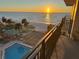 Breathtaking balcony view of ocean, beach, and pool at sunset at 2618 Gulf Blvd # 407, Indian Rocks Beach, FL 33785