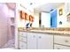 Bathroom with granite countertops, white cabinetry, and a tiled walk-in shower at 2618 Gulf Blvd # 407, Indian Rocks Beach, FL 33785