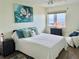 Bright bedroom features calming decor, an ocean view, and a plush, inviting bed at 2618 Gulf Blvd # 407, Indian Rocks Beach, FL 33785