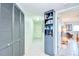 Hallway with built-in bookshelf leading to bedroom at 2618 Gulf Blvd # 407, Indian Rocks Beach, FL 33785
