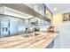 Stylish kitchen with granite countertop, stainless steel appliances, and light grey cabinetry at 2618 Gulf Blvd # 407, Indian Rocks Beach, FL 33785