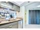 Well-appointed kitchen with granite countertops, stainless appliances, and open to dining area at 2618 Gulf Blvd # 407, Indian Rocks Beach, FL 33785