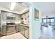 Modern kitchen with stainless steel appliances, granite countertops, and open view to the living area at 2618 Gulf Blvd # 407, Indian Rocks Beach, FL 33785