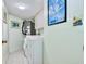 Functional laundry room with modern washer, dryer, and cabinet at 2618 Gulf Blvd # 407, Indian Rocks Beach, FL 33785