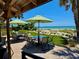 Outdoor patio featuring tables with beach views at 2618 Gulf Blvd # 407, Indian Rocks Beach, FL 33785
