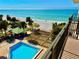 Balcony view featuring a pool, beach access, and ocean views at 2618 Gulf Blvd # 407, Indian Rocks Beach, FL 33785