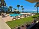 Community pool area with lounge chairs and beach access at 2618 Gulf Blvd # 407, Indian Rocks Beach, FL 33785