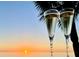 Sunset beach and ocean views with a foreground of flutes of champagne at 2618 Gulf Blvd # 407, Indian Rocks Beach, FL 33785