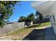 The spacious backyard features mature trees, grass and a partial wood fence at 4803 Guardian Ave, Holiday, FL 34690