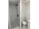 This bathroom features a tiled walk-in shower, toilet, and vanity at 4803 Guardian Ave, Holiday, FL 34690