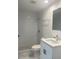 Modern bathroom boasts new vanity, toilet, shower and striking black and white tile at 4803 Guardian Ave, Holiday, FL 34690