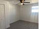 This bedroom features wood-look flooring, a ceiling fan, and a window at 4803 Guardian Ave, Holiday, FL 34690