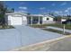 This beautiful home features a garage and a covered front porch, perfect for enjoying the outdoors at 4803 Guardian Ave, Holiday, FL 34690