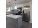 Updated kitchen featuring white cabinets, stainless steel appliances, and a stylish center island at 4803 Guardian Ave, Holiday, FL 34690