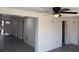 Open living room with gray flooring and ceiling fan provides ample space to relax at 4803 Guardian Ave, Holiday, FL 34690