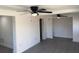 Open living room with gray flooring and ceiling fan provides ample space to relax at 4803 Guardian Ave, Holiday, FL 34690