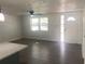 Bright and airy living room featuring hardwood floors, natural light, and a welcoming atmosphere at 4803 Guardian Ave, Holiday, FL 34690