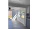 Bright sunroom featuring new gray floors and sliding glass door to back yard at 4803 Guardian Ave, Holiday, FL 34690