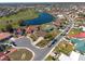 Aerial view of homes in a neighborhood with lakes, golf course, and a beautiful sky at 701 Westmont Way, Sun City Center, FL 33573