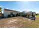 Landscaped backyard with a screened-in lanai and mature landscaping at 701 Westmont Way, Sun City Center, FL 33573