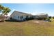 Lush green backyard with a screened-in lanai at 701 Westmont Way, Sun City Center, FL 33573