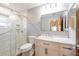 Updated bathroom with glass shower, modern fixtures, and marble countertops at 701 Westmont Way, Sun City Center, FL 33573