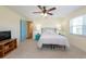 Bedroom with ceiling fan, large window, and wood floors at 701 Westmont Way, Sun City Center, FL 33573
