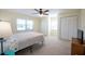 Bright bedroom with carpet, two closets, and a ceiling fan at 701 Westmont Way, Sun City Center, FL 33573
