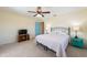 Bedroom with ceiling fan, large window, and wood floors at 701 Westmont Way, Sun City Center, FL 33573