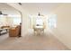 Bright dining room featuring a ceiling fan and large windows, seamlessly connecting to the living room at 701 Westmont Way, Sun City Center, FL 33573