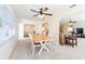 Inviting dining room with a ceiling fan, seamlessly connected to the living room for easy entertaining at 701 Westmont Way, Sun City Center, FL 33573