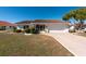 Charming single-story home featuring a tile roof, attached garage, and well-manicured front yard at 701 Westmont Way, Sun City Center, FL 33573
