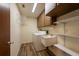 Well-lit laundry room with storage cabinets and utility sink at 701 Westmont Way, Sun City Center, FL 33573