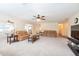 Large living room with neutral carpeting, ceiling fan, and ample seating space at 701 Westmont Way, Sun City Center, FL 33573