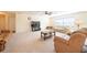 Expansive living room with neutral carpeting, a ceiling fan, and a comfortable seating area at 701 Westmont Way, Sun City Center, FL 33573