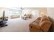 Spacious living room with neutral carpeting, ceiling fan, and ample seating at 701 Westmont Way, Sun City Center, FL 33573