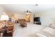 Open living room featuring neutral carpet, ceiling fan, and a spacious layout at 701 Westmont Way, Sun City Center, FL 33573