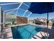 A screened-in pool with a blue umbrella, and outdoor grill provide relaxation and entertainment at 701 Westmont Way, Sun City Center, FL 33573