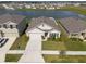 Aerial view of a house and neighborhood with a lake at 816 Will Scarlett Ave, Ruskin, FL 33570