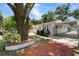 Single-story home with gated driveway and landscaping at 6908 N Oregon Ave, Tampa, FL 33604