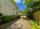 Landscaped side yard with a mulch pathway and lush greenery at 6304 E 113Th Ave, Temple Terrace, FL 33617