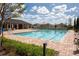 Community pool with lounge chairs and a clubhouse at 816 Will Scarlett Ave, Ruskin, FL 33570