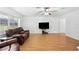 Bright living room with hardwood floors and comfortable leather seating at 36941 Blanton Rd, Dade City, FL 33523